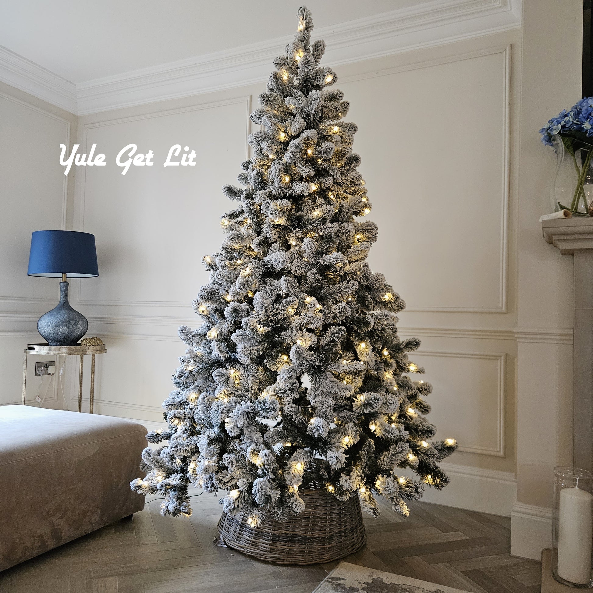 7ft pre lit Christmas tree decorated with green and gold baubles next to a fireplace

