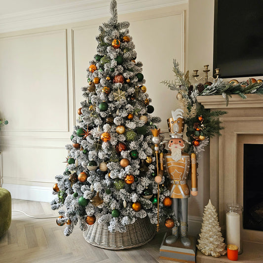 7ft pre lit Christmas tree with warm white LED lights – snow flocked in a living room setting

